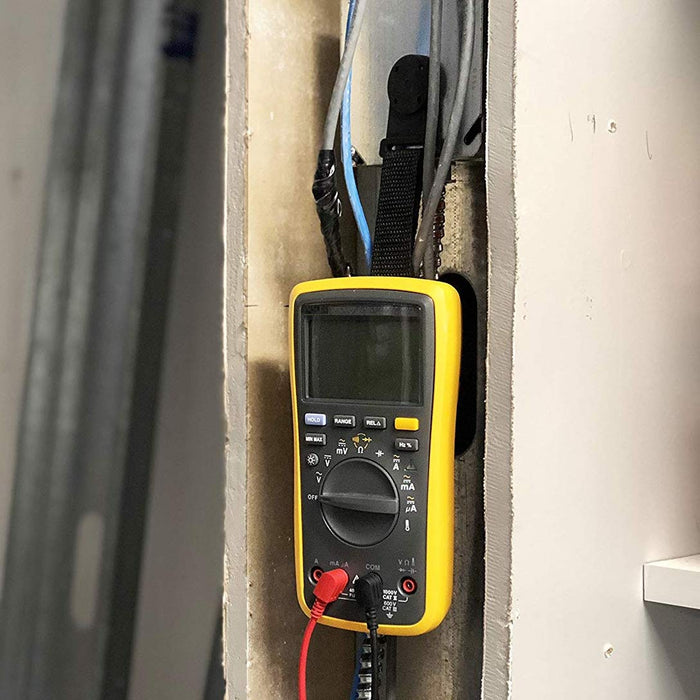 Chromex multimeter magnet kit holding Fluke meter hands-free while testing electrical wiring