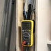 Chromex multimeter magnet kit holding Fluke meter hands-free while testing electrical wiring